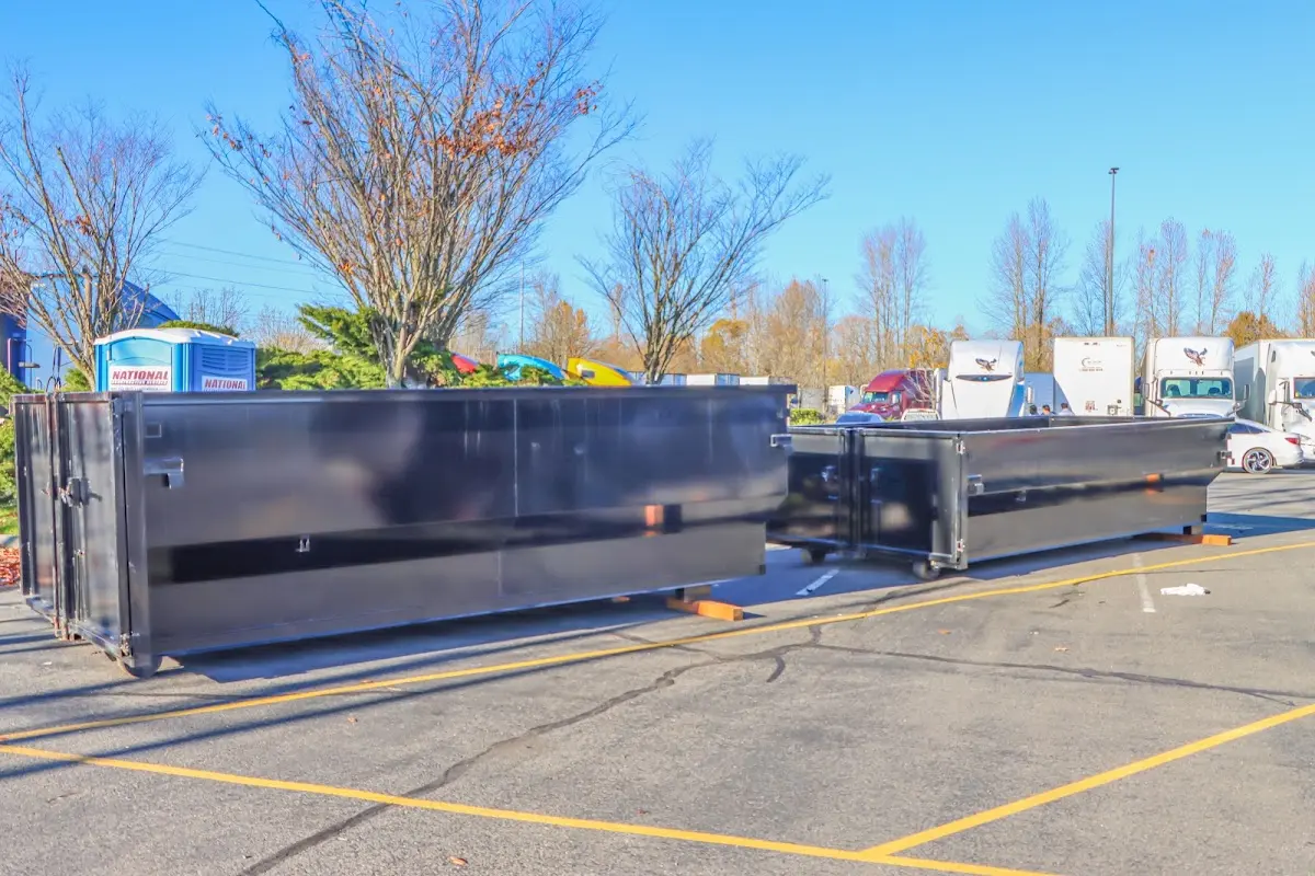 Professional dumpster rental service with roll-off container on residential driveway in Marlboro